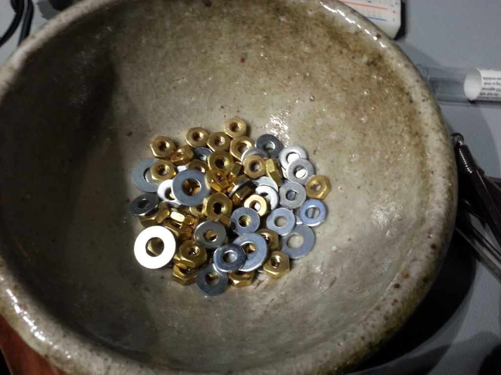 Brass nuts and aluminum washers removed from the hat